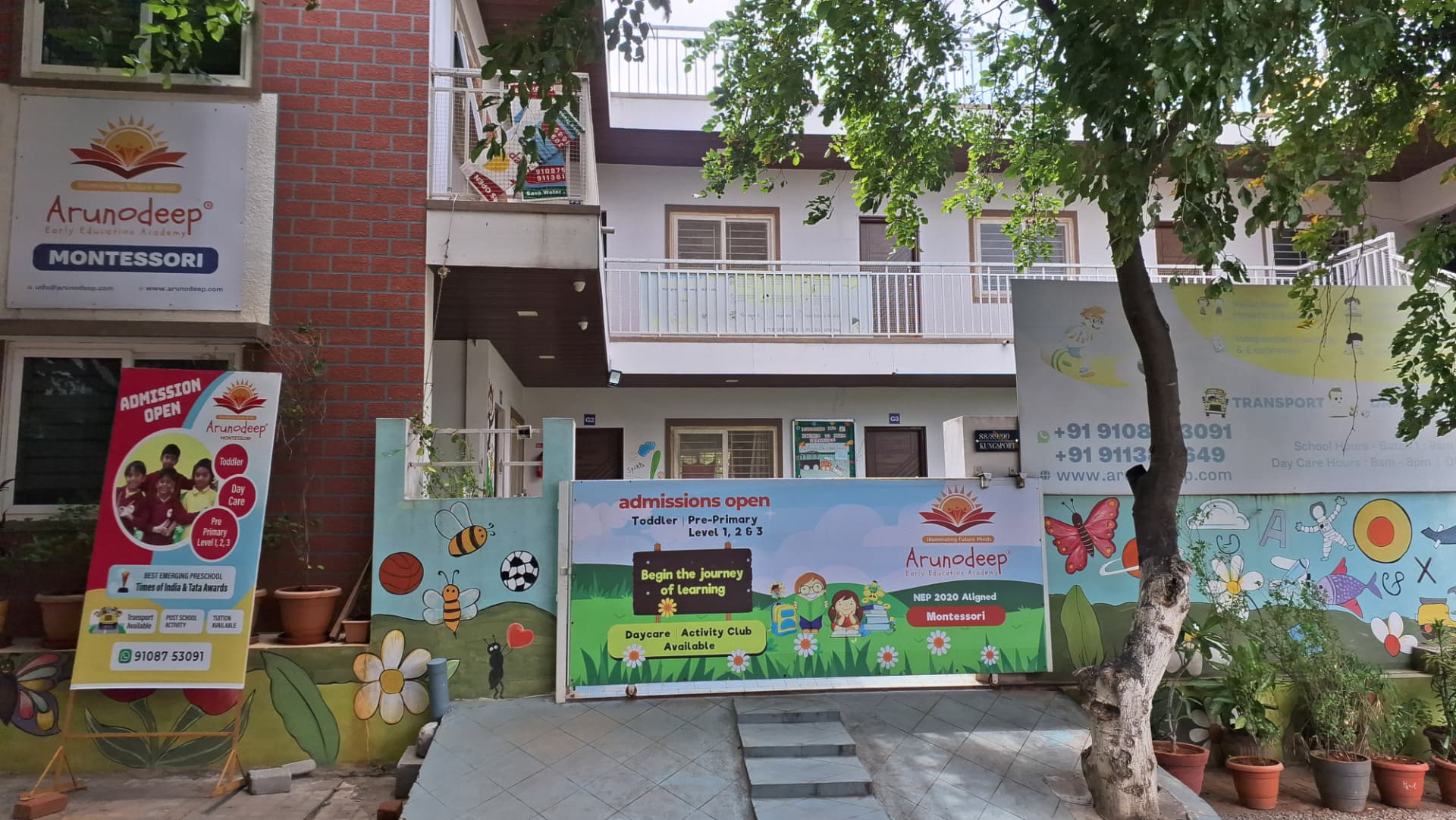 The colourful entrance of Arunodeep Montessori in Haralur, Bengaluru, with murals, classrooms and admissions banners